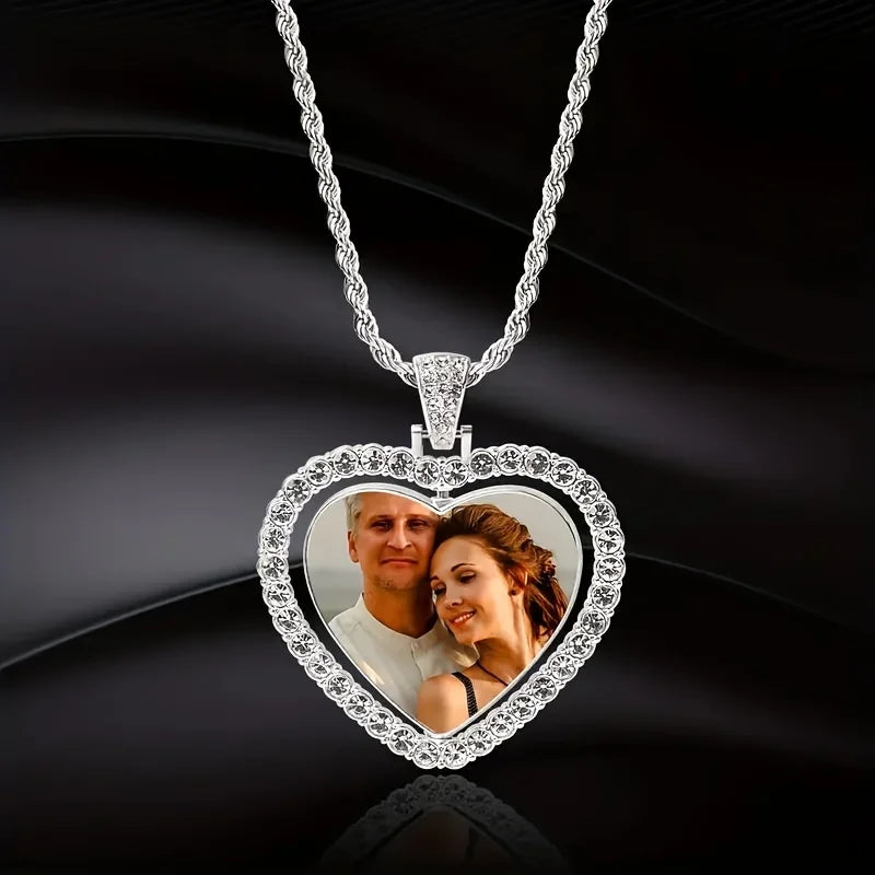 Heart-shaped pendant with a photo of a couple on a dark background