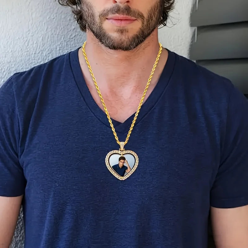 Man wearing a blue shirt with a gold chain necklace featuring a heart-shaped pendant.