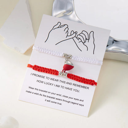 Red and white bracelet with a heart charm on a card with text, on a light background