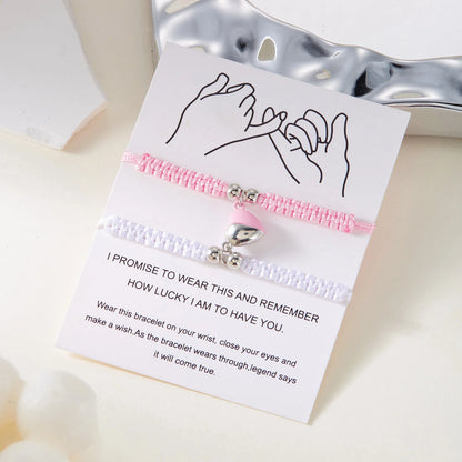 Bracelet with pink and white design on a card with text, on a light background