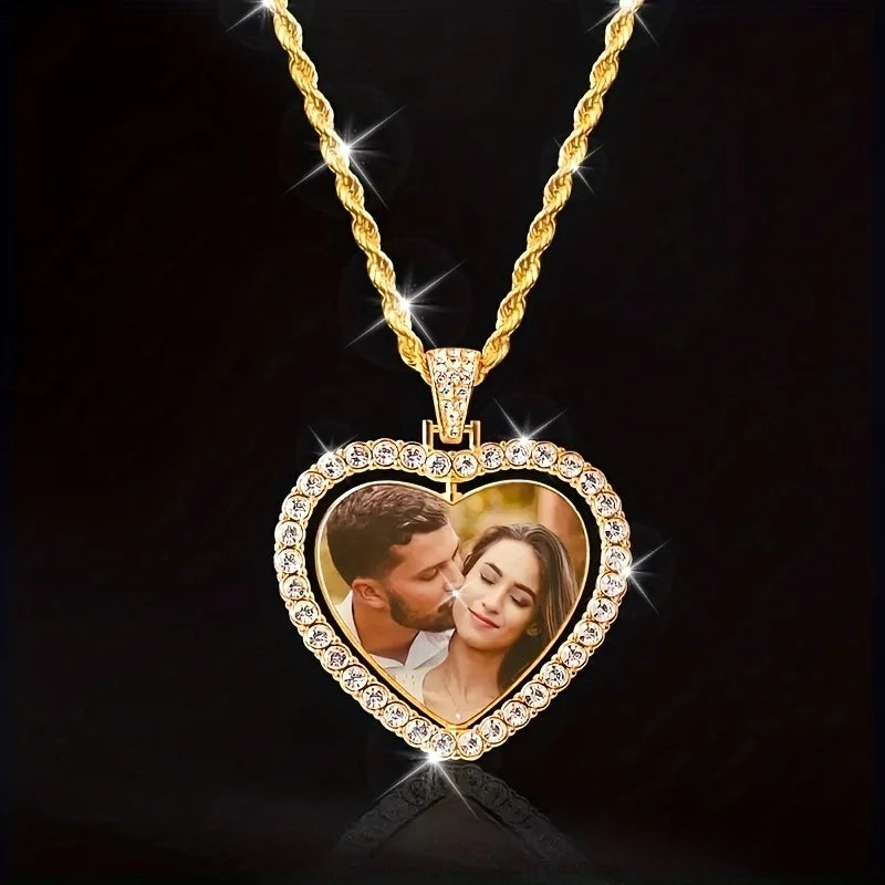 Heart-shaped gold pendant with a photo of a couple on a black background