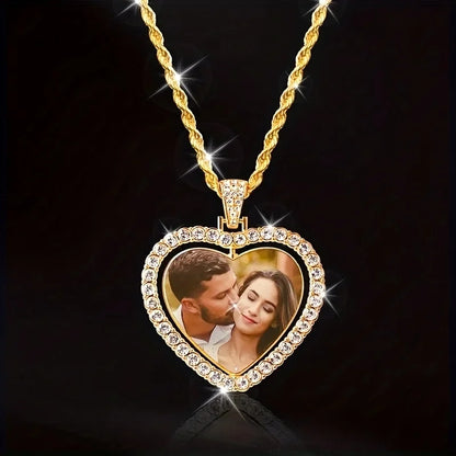 Heart-shaped gold pendant with a photo of a couple on a black background